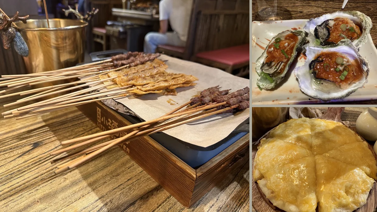 Small plates and drinks on a busy table.
