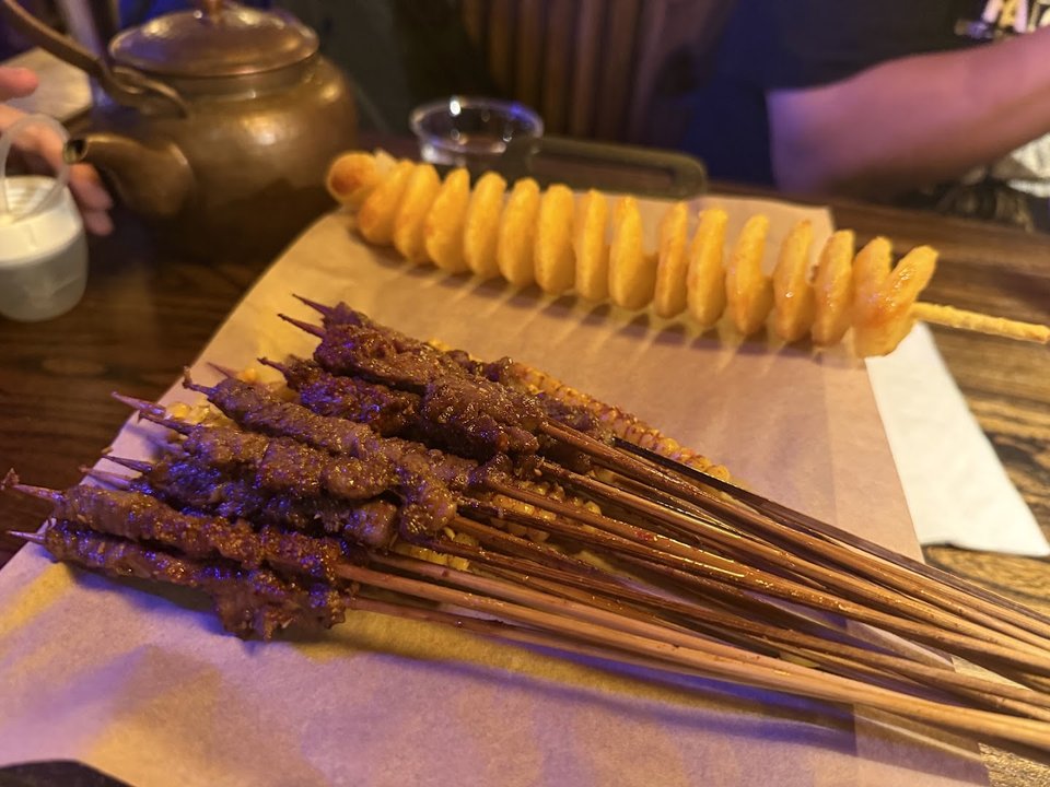 A casual barbecue table with shared plates.